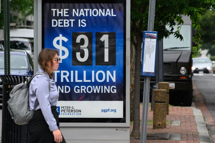 A poster on a Washington, D.C., bus shelter shows the national debt as of Friday.