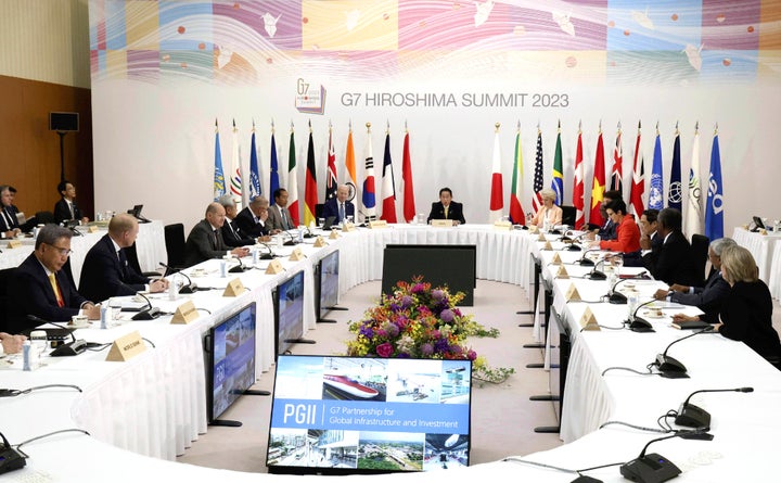 U.S. President Joe Biden, rear left, Japanese Prime Minister Fumio Kishida, rear center, and European Commission President Ursula von der Leyen, rear right, with other world leaders, attend an event on global infrastructure and investment during the G7 Summit in Hiroshima, Japan, Saturday, May 20, 2023. (Japan Pool via AP)