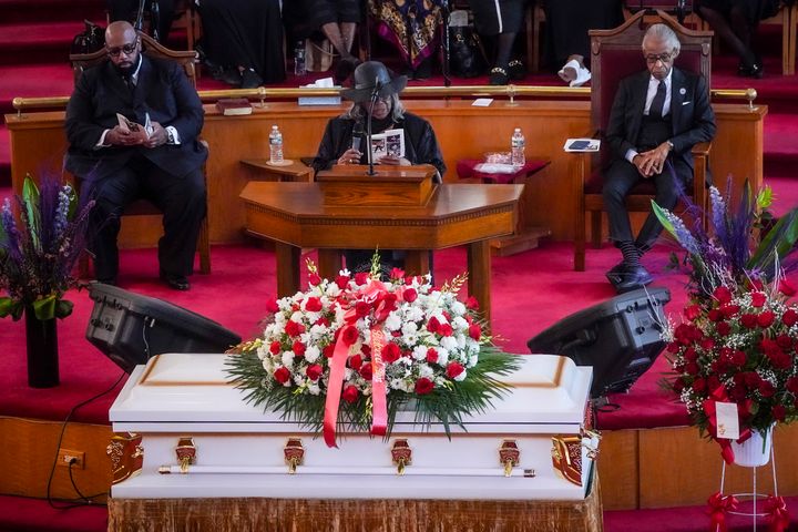Rev. Al Sharpton, right, and Rev. Dr. Johnnie Green, left, is seated listening as Mildred Mahazu, center, grand aunt of Jordan Neely—the victim of a deathly chokehold on a subway, speak during Neely's funeral service at Harlem's Mount Neboh Baptist Church, Friday May 19, 2023, in New York. (AP Photo/Bebeto Matthews)