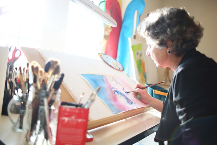 The author painting. (This photo is part of artist series "Women of Charlottesville" from 2020.)