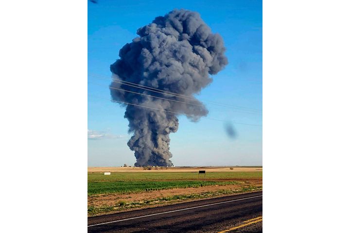 In this photo provided by Castro County Emergency Management, smoke fills the sky after an explosion and fire at the Southfork Dairy Farms near Dimmitt, Texas, on April 10, 2023.