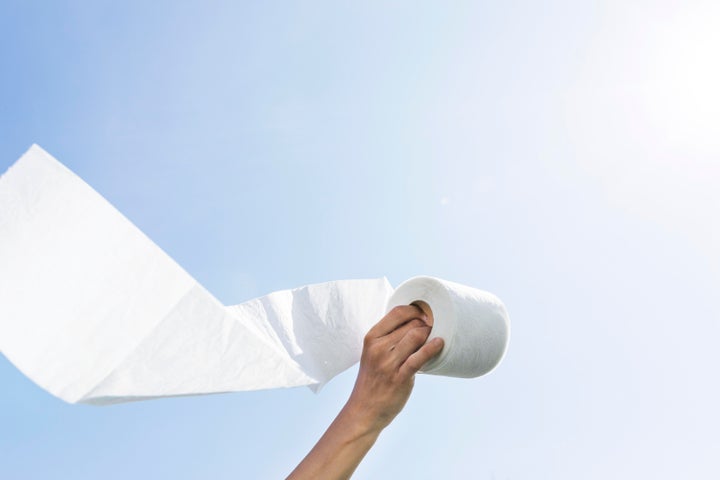 hand with toilet paper roll