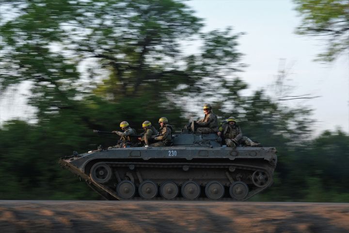 Ukrainian soldiers ride on a BMP infantry fighting vehicle toward Bakhmut, on May 20, 2023.