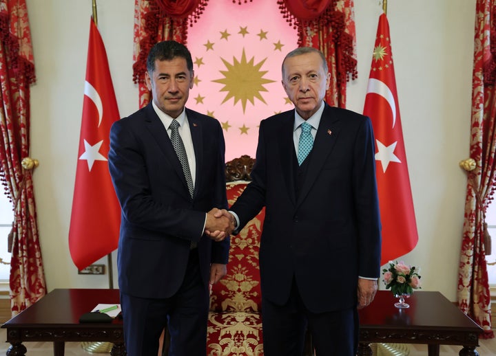 In this photo released by Turkish Presidency, Turkish President and People's Alliance's presidential candidate Recep Tayyip Erdogan, right, shakes hands with Sinan Ogan, former presidential candidate from ATA alliance, in Istanbul, Turkey, on May 19, 2023.