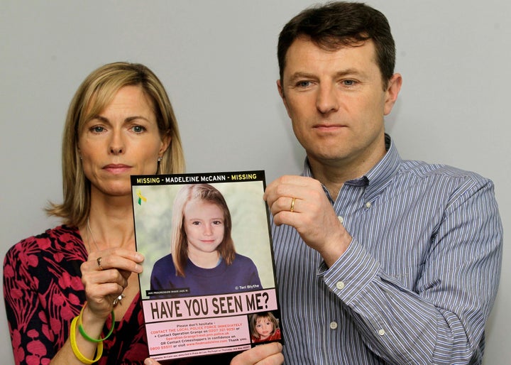 Kate and Gerry McCann pose for the media with a missing poster showing a computer-generated age-history image of their still missing daughter Madeleine during a news conference in London May 2, 2012.