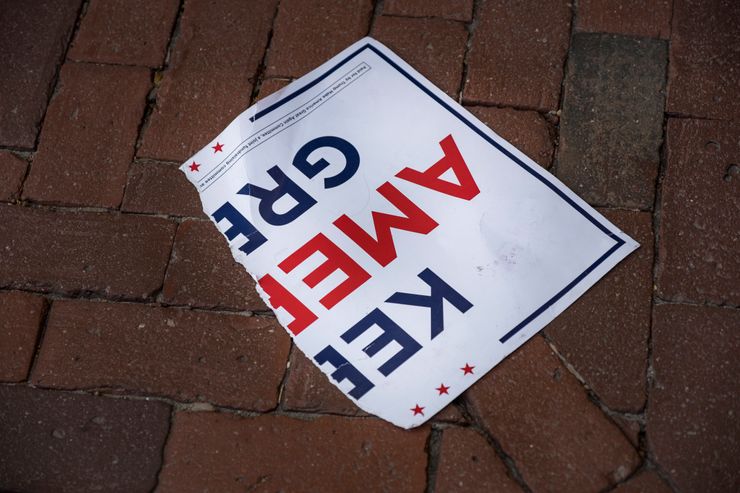 A torn poster on the ground outside the Massachusetts State House in Boston after skirmishes broke out during a demonstration by both Joe Biden and Trump supporters on Nov. 7, 2020, the day that the news broke that Biden was declared the winner of the U.S. presidential election.