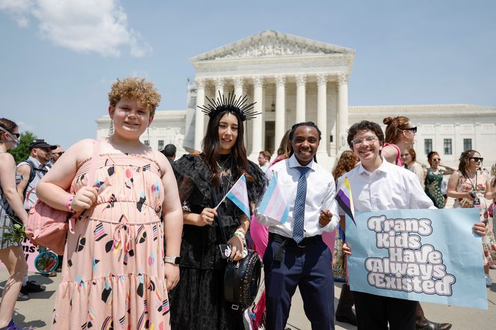 Trans Youth Prom organizers Grayson McFerrin, 12, Libby Gonzales, 13, Hobbes Chukumba, 16, and Daniel Trujillo, 15, pose for a photo in front of the U.S. Supreme Court Building on May 22.