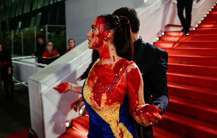 Ukrainian model and fitness instructor Ilona Chernobai is detained by security Sunday after she covered herself in fake blood at the Cannes Film Festival.