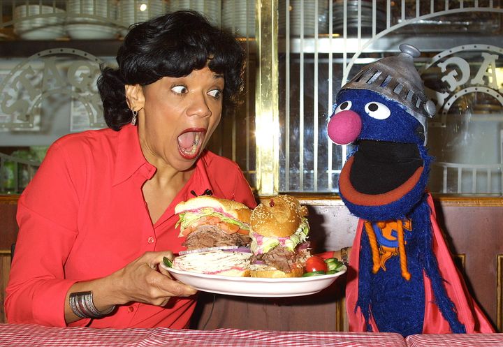 The author and the Muppet Grover launch the Super Grover sandwich in honour of the 4,000th "Sesame Street" episode on Feb. 27, 2002, at a New York City deli.