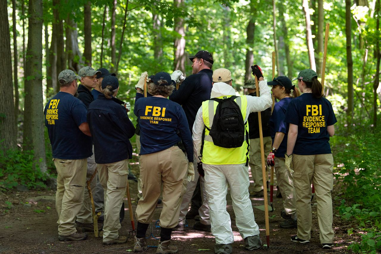 An FBI team combs a heavily wooded area in Waveny Park in New Canaan, Connecticut, on June 3, 2019.