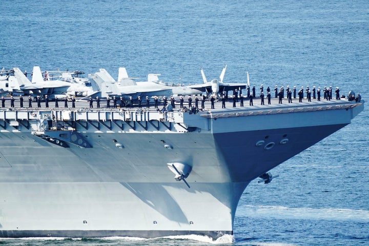 Soldiers protect the U.S. aircraft carrier USS Gerald R. Ford on its way into the Oslo Fjord, at Drobak Moss, Norway, May 24, 2023. Terje Pedersen/NTB/via REUTERS ATTENTION EDITORS - THIS IMAGE WAS PROVIDED BY A THIRD PARTY. NORWAY OUT. NO COMMERCIAL OR EDITORIAL SALES IN NORWAY.