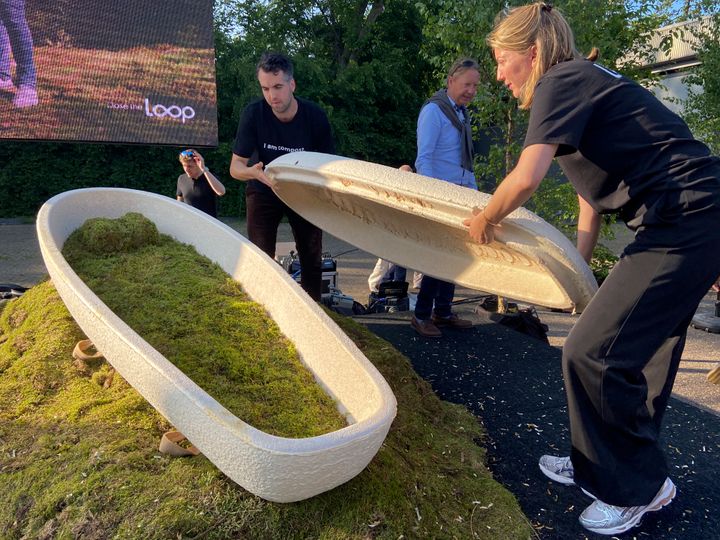 Director Lonneke Westhoff, right, and founder Bob Hendrikx, left, of Dutch startup Loop Biotech display one of the cocoon-like coffins, grown from local mushrooms and up-cycled hemp fibers.