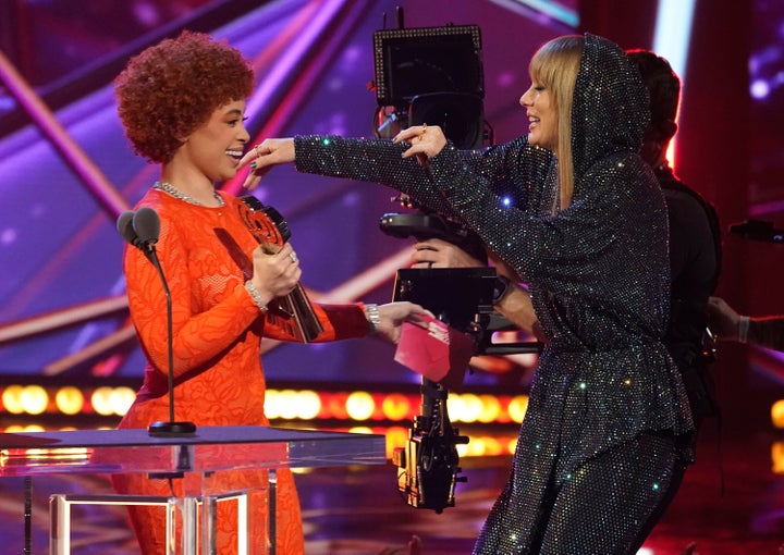 Ice Spice, left, presents Taylor Swift with the award for song of the year for "Anti-Hero" at the iHeartRadio Music Awards in March. The two are teaming up on a new version of "Karma." 