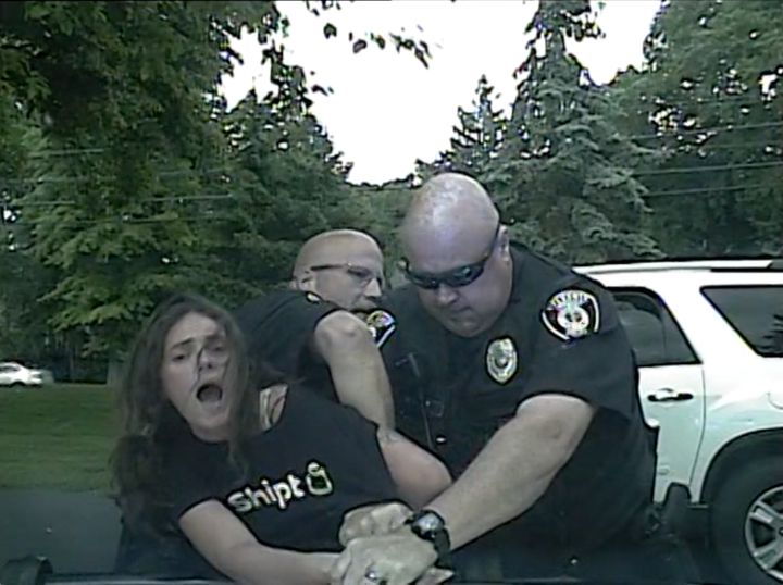 Dashcam footage shows Sylvania Township Police officers John Tanner and Michael Wyatt restraining Caitlin Taylor. The footage was provided by her attorney.