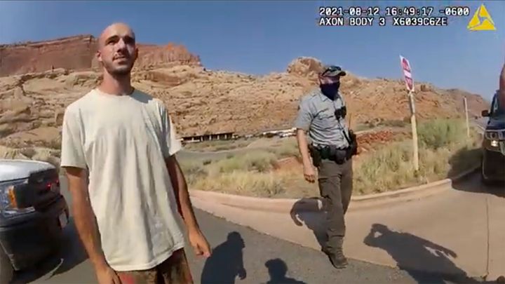 Brian Laundrie talks to a Moab, Utah, police officer after police pulled over the van he was traveling in with Gabby Petito near the entrance to Arches National Park on Aug. 12, 2021.