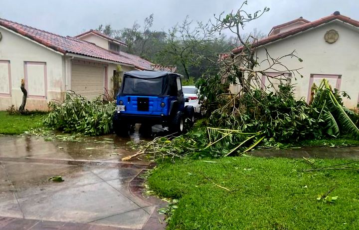 In this photo provided by the U.S. Coast Guard, downed tree branches litter a neighborhood in Yona, Guam, Thursday, May 25, 2023, after Typhoon Mawar passed over the island. (Chief Warrant Officer Adam Brown/U.S. Coast Guard via AP)