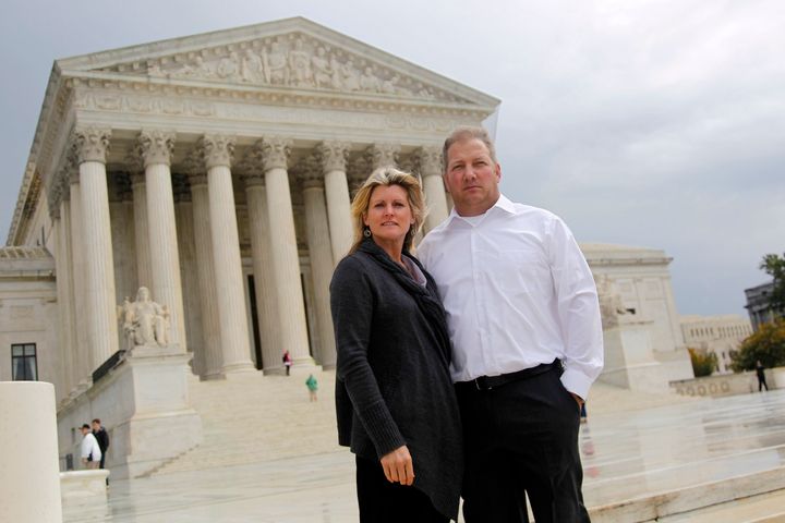 FILE - Michael and Chantell Sackett of Priest Lake, Idaho, pose for a photo in front of the Supreme Court in Washington on Oct. 14, 2011. The Supreme Court on Thursday, May 25, 2023, made it harder for the federal government to police water pollution in a decision that strips protections from wetlands that are isolated from larger bodies of water. The justices boosted property rights over concerns about clean water in a ruling in favor of an Idaho couple who sought to build a house near Priest Lake in the state’s panhandle. (AP Photo/Haraz N. Ghanbari, File)