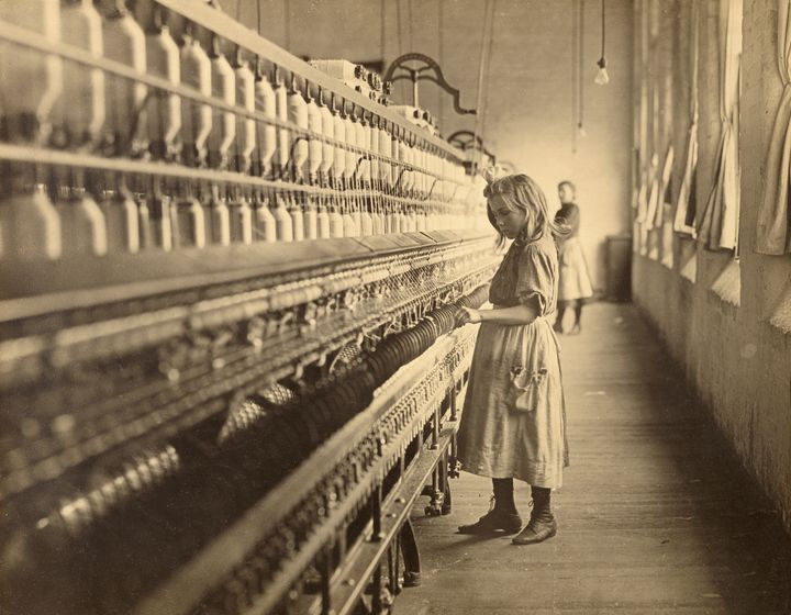 A young girl works in a South Carolina cotton mill in 1908. Photographs such as this one helped convince the American public of the need for child labor laws in the early 20th century. 