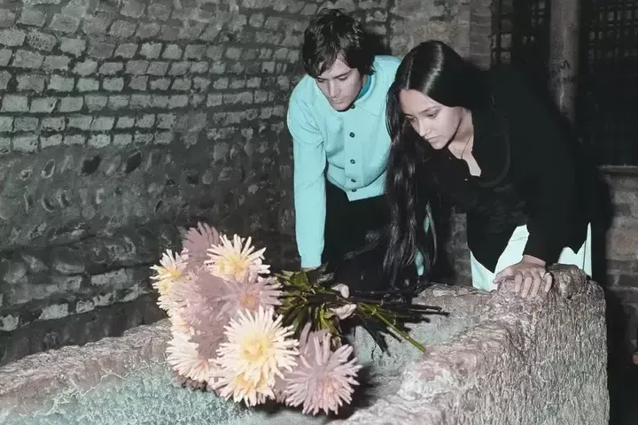 FILE - Olivia Hussey and Leonard Whiting, who played the lead roles in Franco Zeffirelli's film. "Romeo and Juliet," place flowers in the "giulietta tomb," or Juliet's Tomb, in Verona, northern Italy, on October 22, 1968.