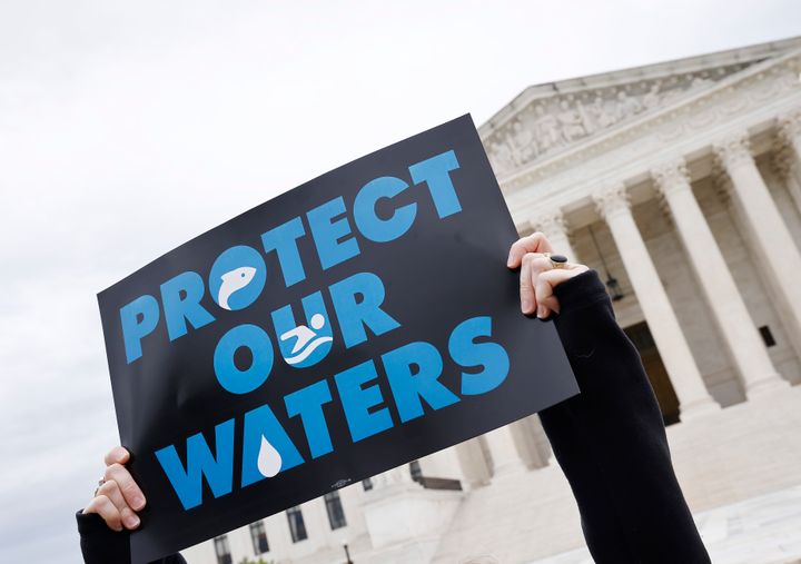 An environmental advocate holds up a sign during a rally outside the Supreme Court in October. (Photo by Paul Morigi/Getty Images for Protect our Waters)