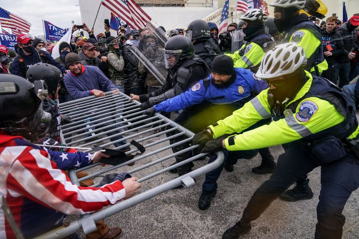This photo taken on Jan. 6, 2021, shows rioters trying to break through a police barrier at the Capitol in Washington.