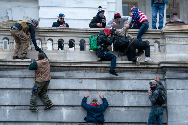 Insurrections climb the west wall of the U.S. Capitol on Jan. 6, 2021.