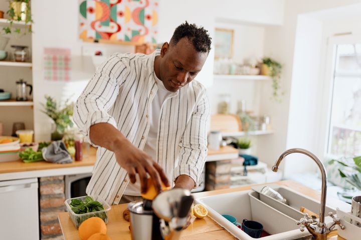 Man drinking fresh homemade juice in the kitchen