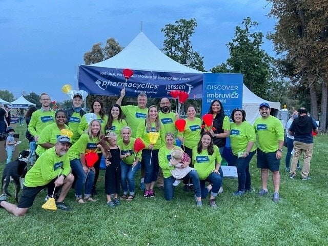 A group of people at the Pharmacyclics & Janssen tent during a Light The Night event