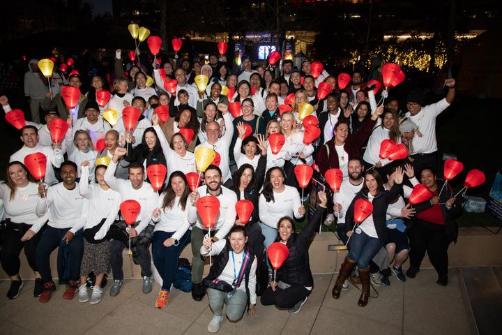 A group of employees from Kite, a Gilead Company, smiling with lanterns at a 2022 Light the Night event.