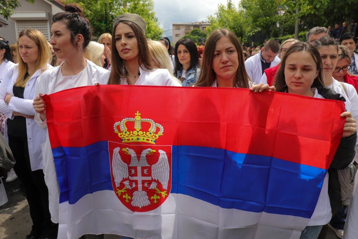 People attend a protest rally in front of the city hall in the town of Zvecan, northern Kosovo, Wednesday, May 31, 2023. Hundreds of ethnic Serbs began gathering in front of the city hall in their repeated efforts to take over the offices of one of the municipalities where ethnic Albanian mayors took up their posts last week.