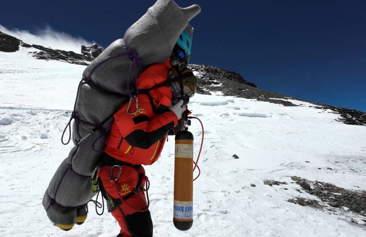 Ngima Tashi Sherpa walks as he carries a Malaysian climber while rescuing him from the death zone above camp four at Everest, Nepal, May 18, 2023 in this screengrab obtained from a handout video. 