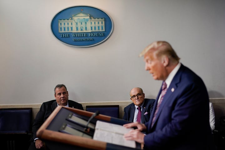 Former New Jersey Gov. Chris Christie (left) and Rudy Giuliani, an attorney for President Donald Trump, listen to Trump at a White House news conference on Sept. 27, 2020.