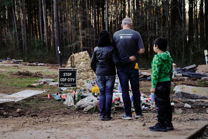 Family members of environmental activist Manuel Estaban Paez Terán visit a makeshift memorial for him in February. Terán was fatally shot in January by law enforcement during a raid to clear the construction site of the police training facility that activists have nicknamed "Cop City."