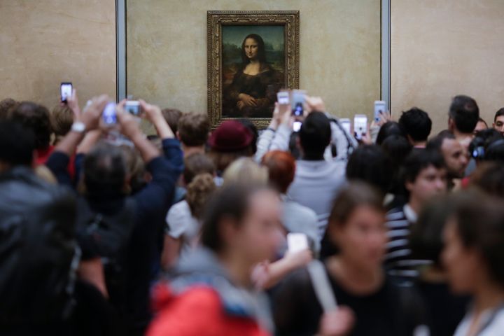 Visitors crowded in front of Leonardo da Vinci's painting 'Mona Lisa' at Musée du Louvre in Paris.