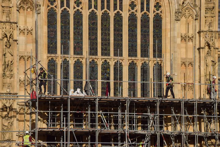 Workers remove the scaffolding from parts of the Palace of Westminster.