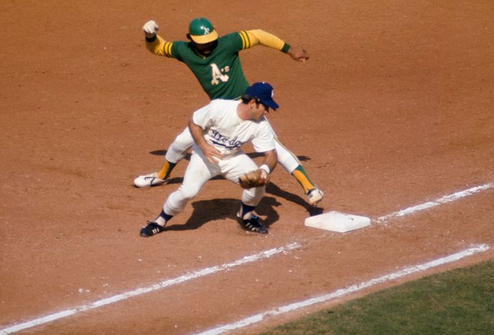 Steve Garvey tries to tag Reggie Jackson of the Oakland A's during the 1974 World Series.