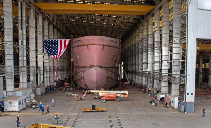 Workers in Louisiana, seen here in April, assemble a ship that will be used to house offshore wind energy workers and their equipment.