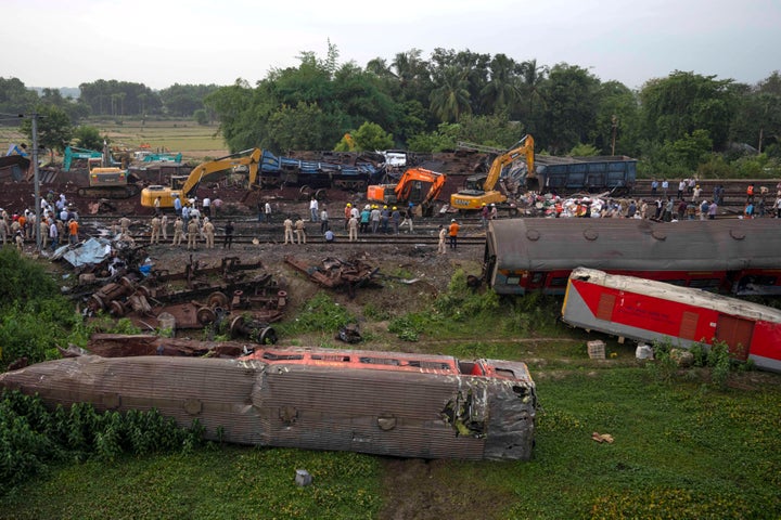People watch at the site where trains that derailed, in Balasore district, in the eastern Indian state of Orissa, Sunday, June 4, 2023. (AP Photo/Rafiq Maqbool)
