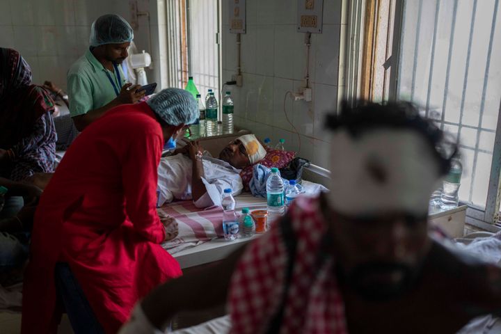 A passenger who was injured in Friday's train accident is examined by doctors at a hospital in Balasore district, in the eastern state of Orissa, India, Sunday, June 4, 2023. (AP Photo/Rafiq Maqbool)