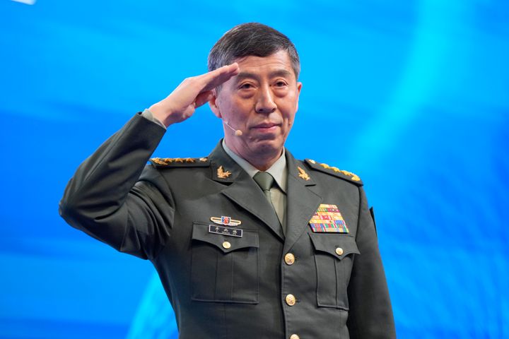Chinese Defense Minister Li Shangfu salutes before delivering his speech on the last day of the 20th International Institute for Strategic Studies (IISS) Shangri-La Dialogue, Asia's annual defense and security forum, in Singapore, Sunday, June 4, 2023. (AP Photo/Vincent Thian)