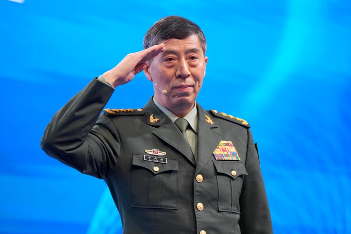 Chinese Defense Minister Li Shangfu salutes before delivering his speech on the last day of the 20th International Institute for Strategic Studies (IISS) Shangri-La Dialogue, Asia's annual defense and security forum, in Singapore, Sunday, June 4, 2023. (AP Photo/Vincent Thian)