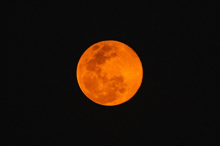 Low angle view of moon against clear sky at night