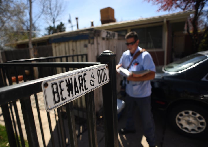 A postal worker delivers mail in Denver, Colorado, on April 6, 2017.