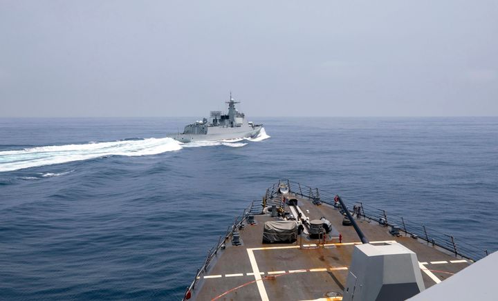 In this photo provided by the US Navy, the USS Chung-Hoon watches as a Chinese naval ship conduct a so-called operation "unsafe” Chinese maneuvers in the Taiwan Strait on Saturday.