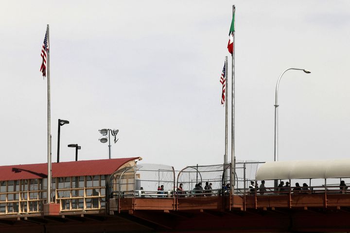 The migrants said they were approached by people outside of a migrant center in El Paso, Texas. Central American migrants walk along a bridge from El Paso to Mexico after being expelled from the U.S.