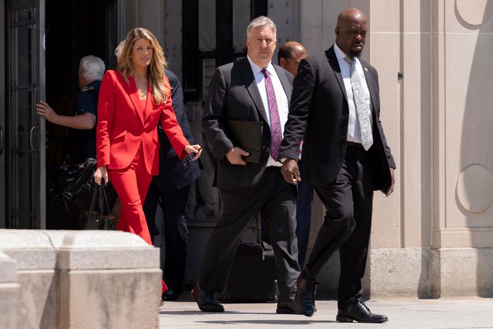 President Donald Trump's lawyers, James Trusty, center, and Lindsey Halligan, left, leave the Department of Justice on Monday in Washington.