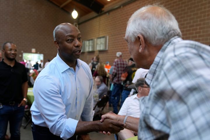 Sen. Tim Scott (R-S.C.), a presidential candidate, greets an audience member Saturday at Sen. Joni Ernst's Roast and Ride, an informal campaign kickoff event, in Des Moines, Iowa. 
