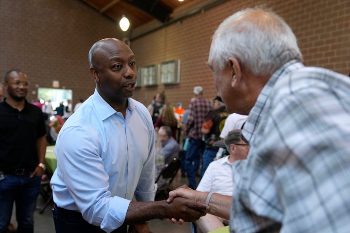 Sen. Tim Scott (R-S.C.), a presidential candidate, greets an audience member Saturday at Sen. Joni Ernst's Roast and Ride, an informal campaign kickoff event, in Des Moines, Iowa.