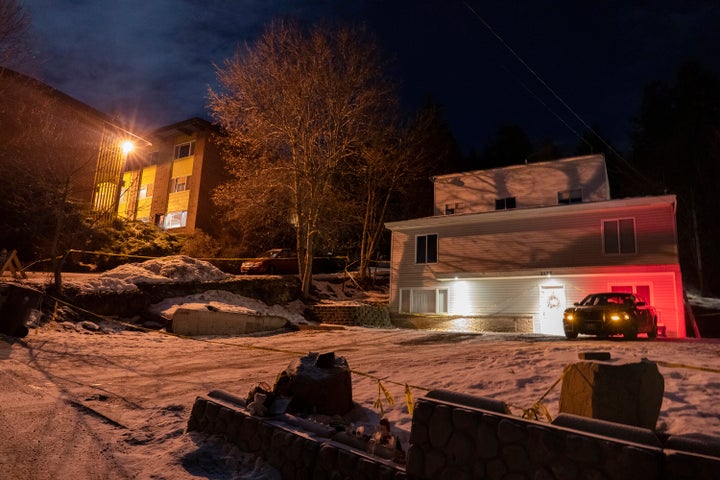 A private security officer sits in a vehicle in front of the house in Moscow, Idaho, where four University of Idaho students were killed in November 2022.