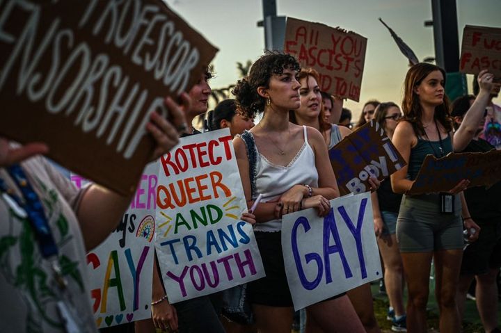 LGBTQ+ rights supporters protest against Florida Gov. Ron DeSantis' policies outside his campaign event.